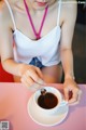 A woman is pouring coffee into a cup.