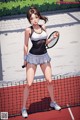 A woman holding a tennis racket on a tennis court.