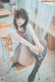 A girl sitting on a chair in a classroom.